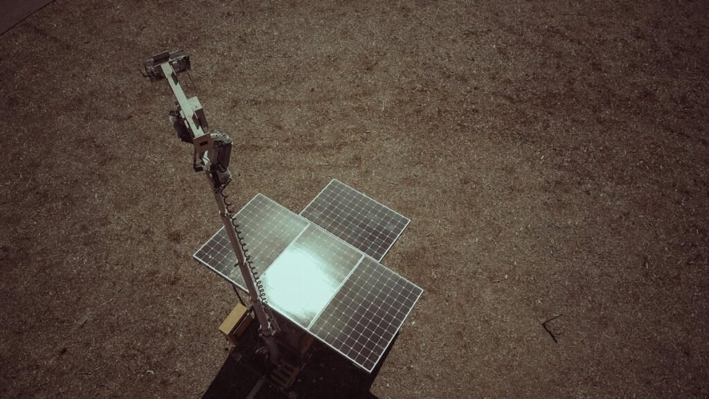 Drone view of solar panels on a dry and barren landscape emphasizing renewable energy.