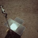 Drone view of solar panels on a dry and barren landscape emphasizing renewable energy.