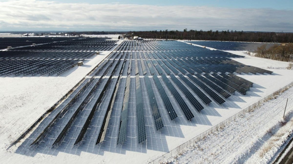 Aerial view of a solar farm in snowy Arnprior, Ontario, showcasing renewable energy.