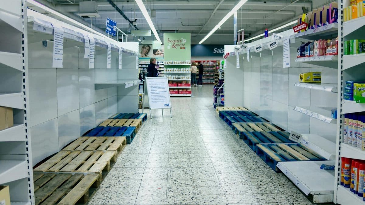 Empty supermarket shelves in Bielefeld, Germany, depicting a shortage or high demand situation.