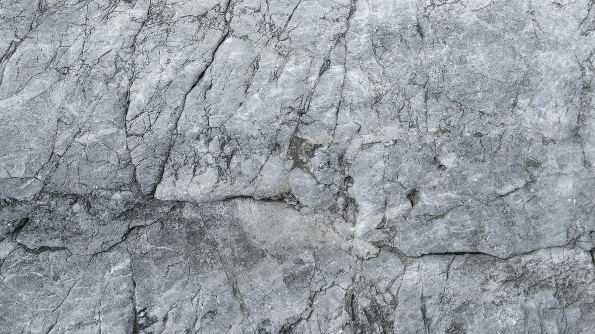 High-resolution close-up image showcasing the intricate texture of natural stone with visible cracks and patterns.