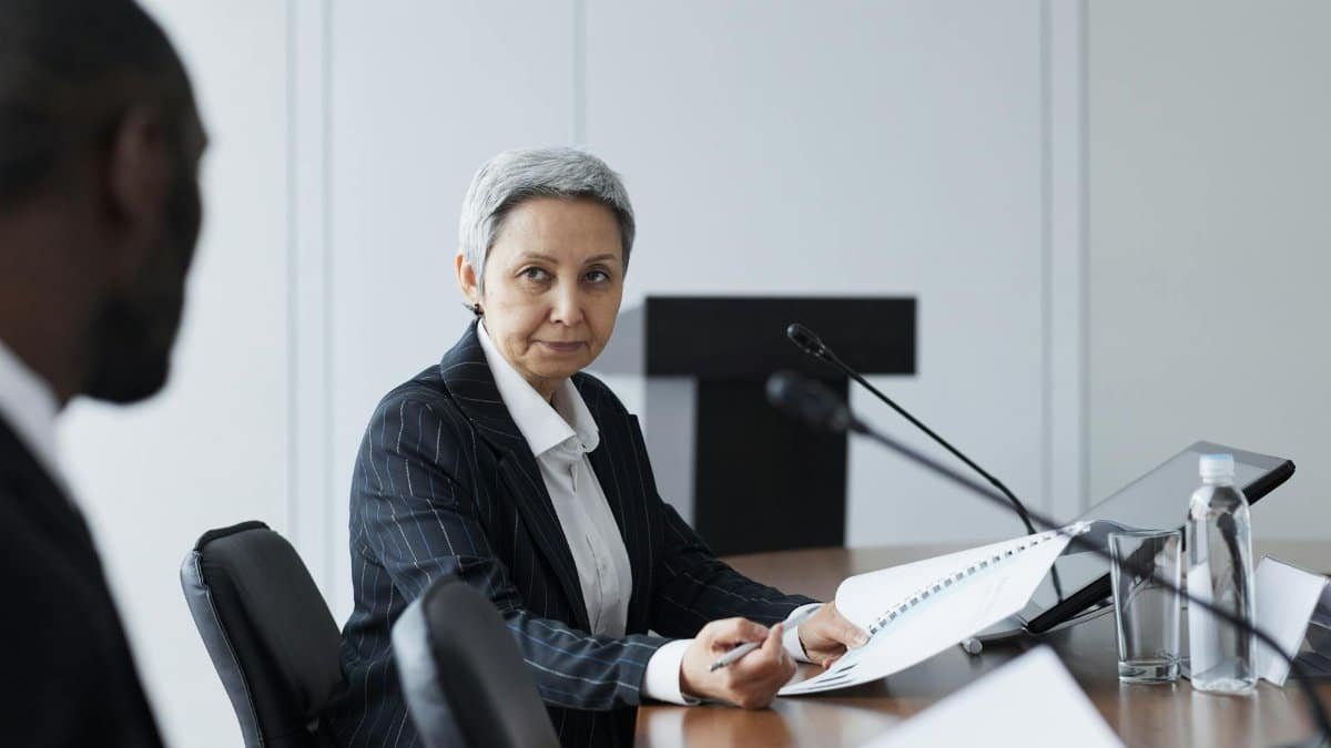 Senior businesswoman leading a conference discussion with a diverse team.