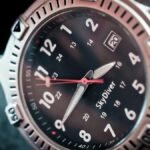 Close-up shot of a sleek diver's wristwatch with labeled time and date display, ideal for adventure seekers.