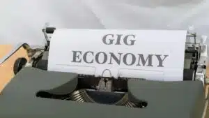 Close-up of a typewriter typing 'Gig Economy', symbolizing modern freelance work.