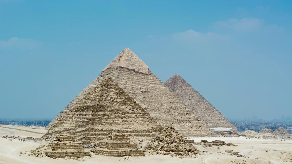 A stunning view of the Great Pyramids of Giza against a clear blue sky in Egypt.
