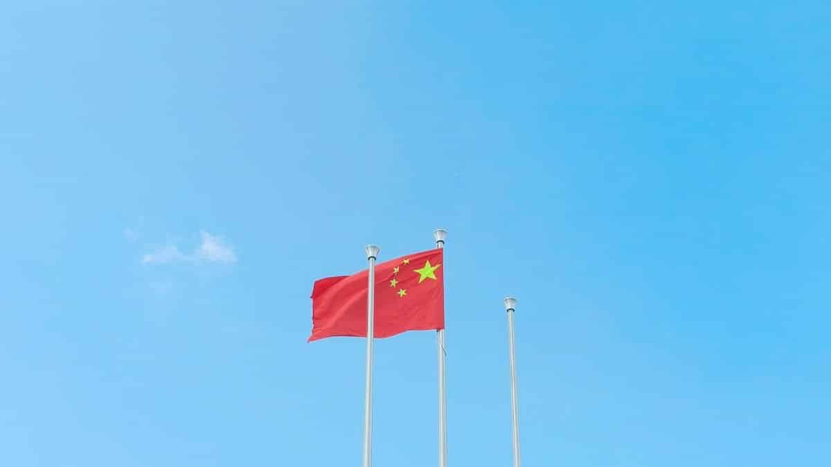 Vibrant Chinese flag waving on a sunny day, symbolizing unity and patriotism.