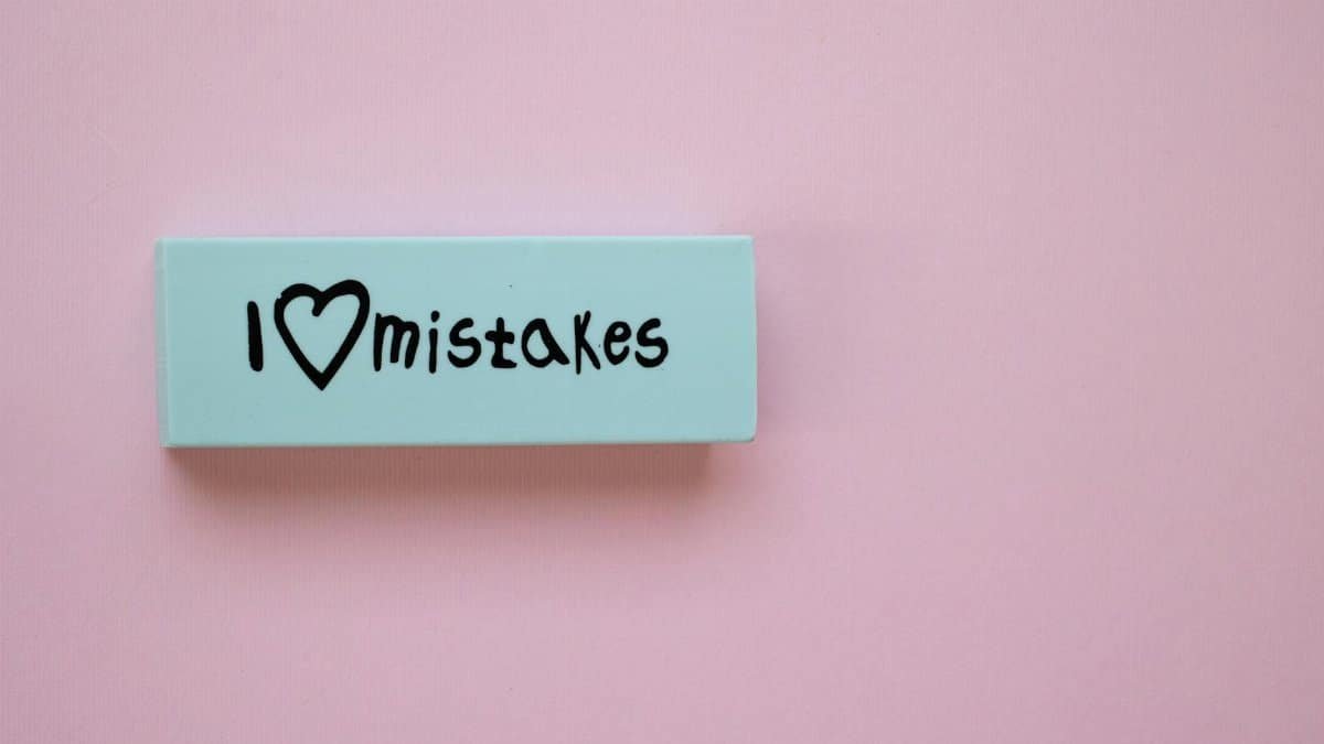 Minimalist eraser with 'I Love Mistakes' message on pink background, school stationery.