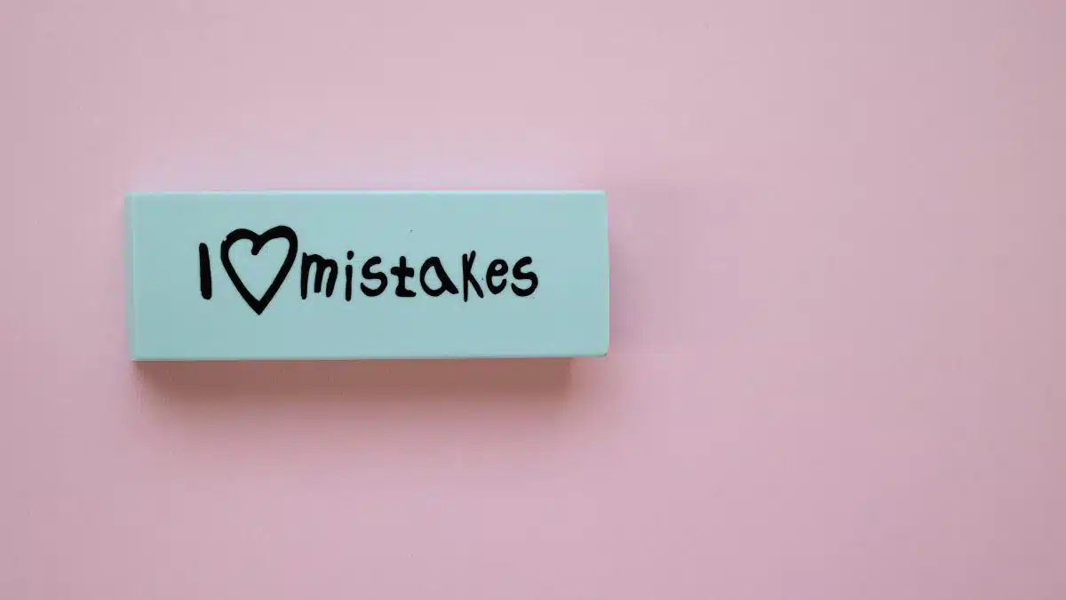 Minimalist eraser with 'I Love Mistakes' message on pink background, school stationery.