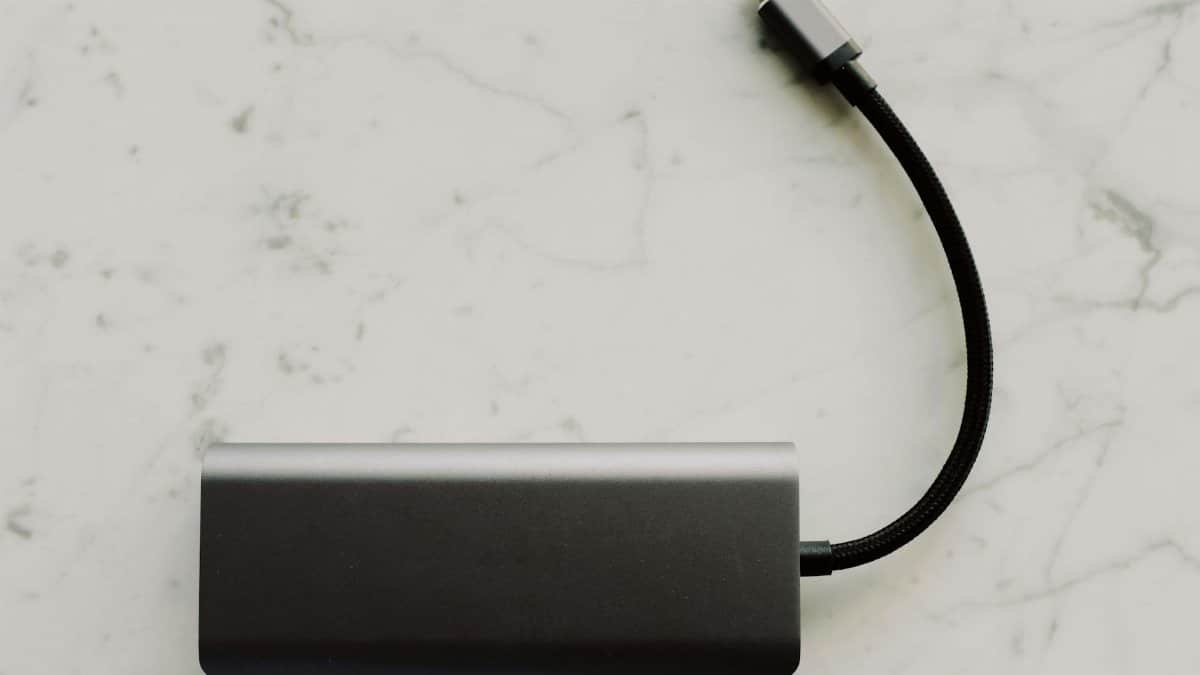 Sleek power bank with USB-C cable on a marble surface, ideal for travel tech needs.