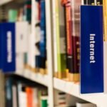 Close-up of a library shelf with books on internet and technology. Ideal for education-themed projects.