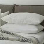 Modern bedroom featuring clean white bedding and pillows for a cozy and inviting atmosphere.