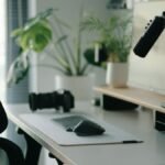 Stylish home office setup with ergonomic chair, plants, and tech accessories creating a modern work environment.