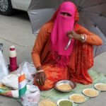 Indian street vendor in Jaipur offering grains under an umbrella with QR code payment option.