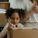 A mother and her daughter pack boxes while moving into their new home, embracing family life.