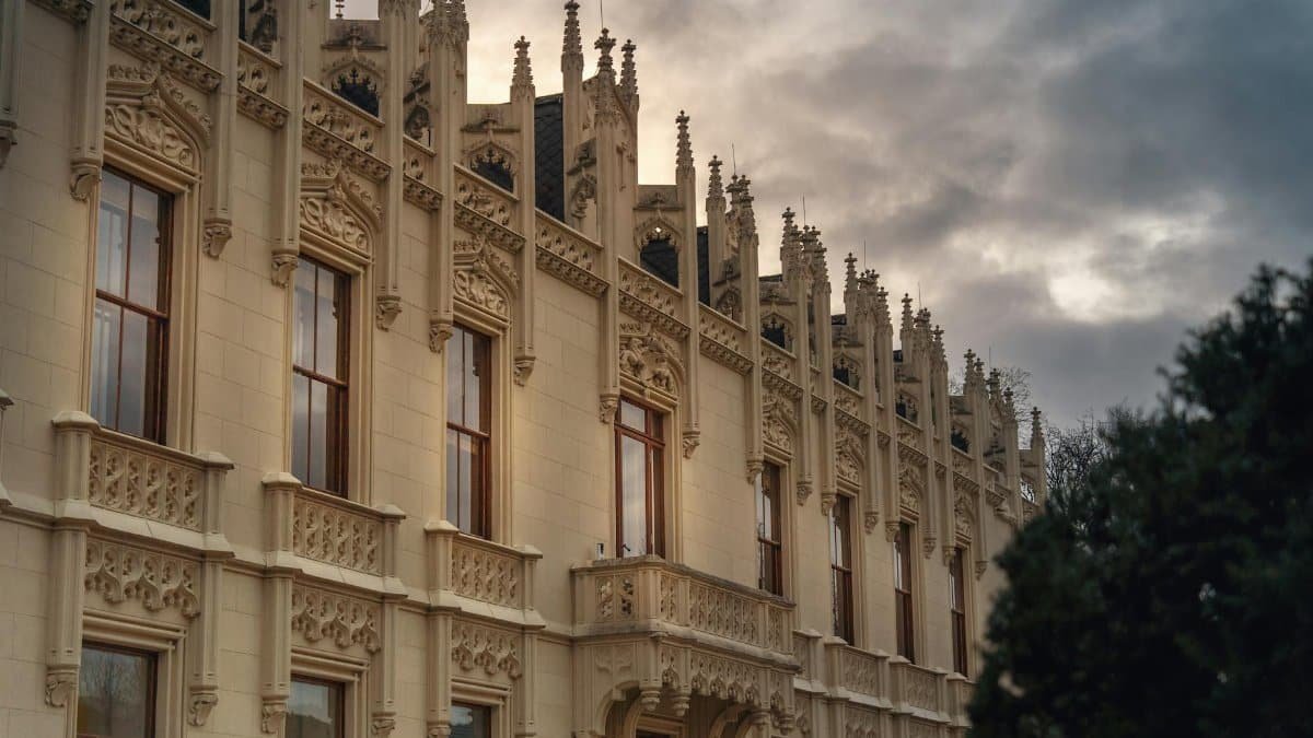 Ornate Gothic Revival building facade in Vienna, Austria during an overcast evening.