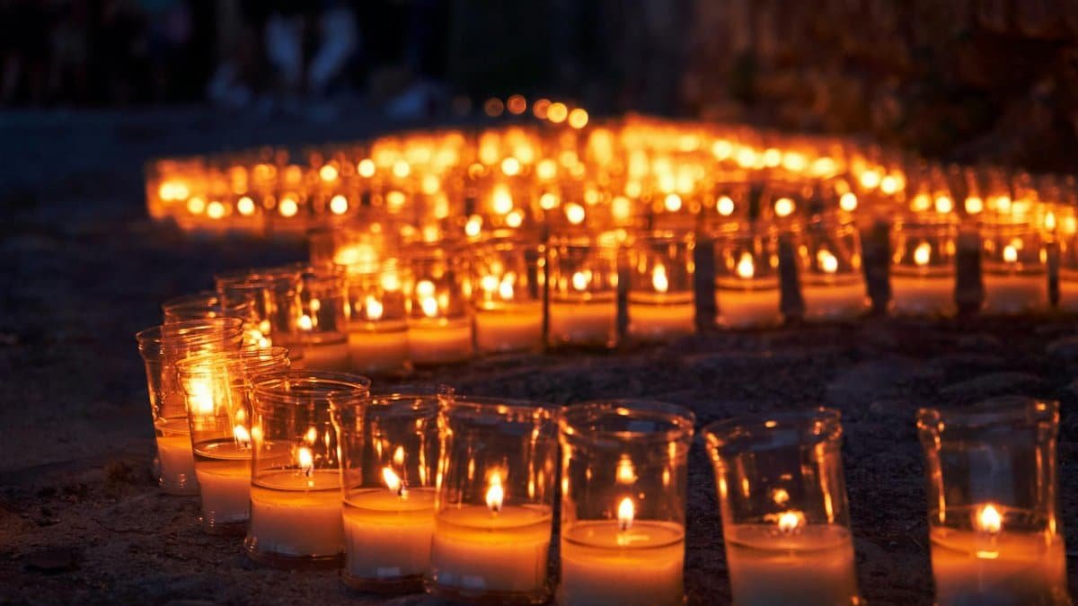 Serene candlelit pathway in Pedraza, Spain during a nighttime festival.