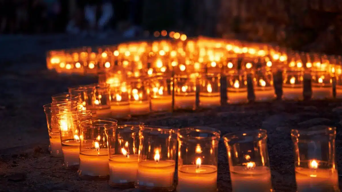 Serene candlelit pathway in Pedraza, Spain during a nighttime festival.