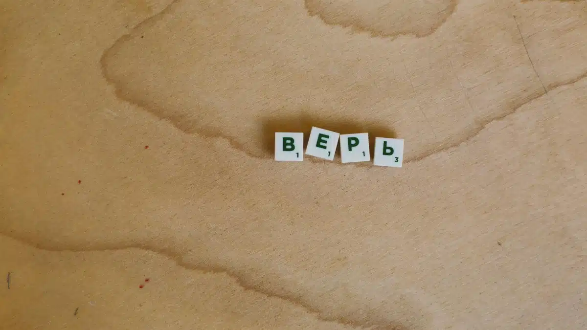 Scrabble tiles with Cyrillic letters spelling 'верь' displayed on a wooden surface.