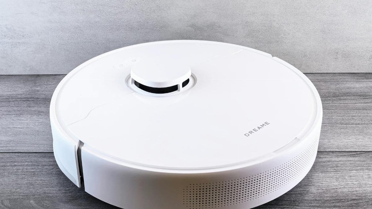 Sleek white robot vacuum cleaner on a wooden floor, perfect for smart home setups.