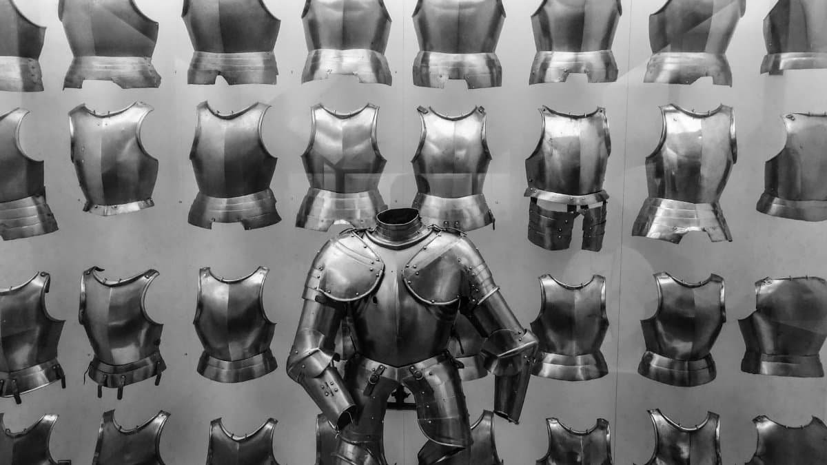 A striking display of medieval knight armor, showcasing breastplates and steel suits in a museum.