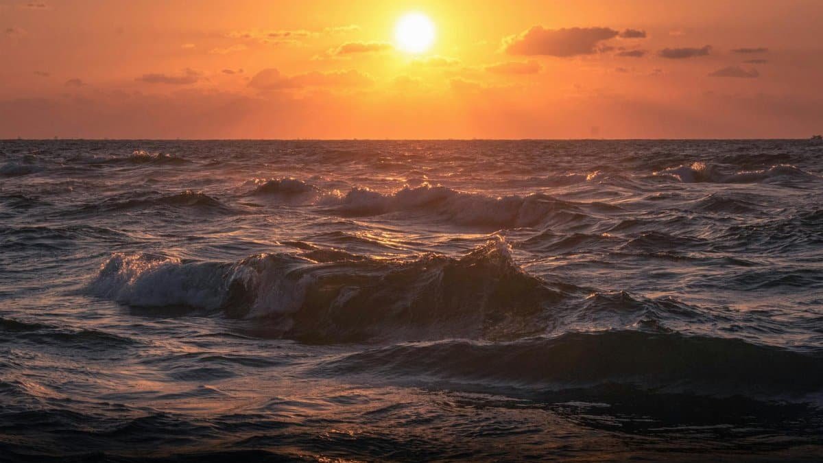 Captivating sunset over the ocean waves in Alexandria, Egypt, during golden hour.