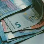 Detailed close-up of various Euro banknotes on a white surface, perfect for finance-related content.