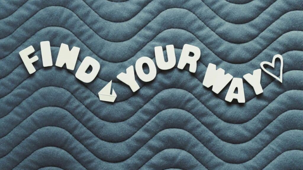 Motivational quote 'Find Your Way' on wave pattern background with heart icon.