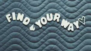 Motivational quote 'Find Your Way' on wave pattern background with heart icon.