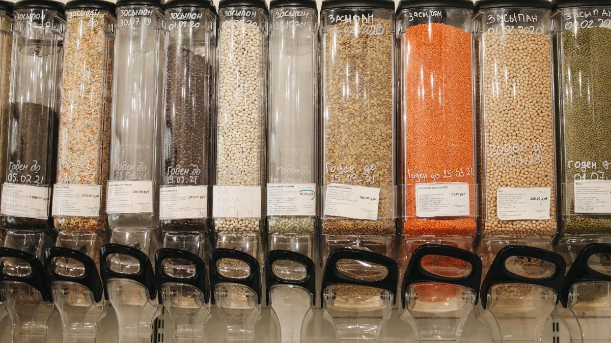 Row of eco-friendly bulk food dispensers in a shop promoting zero waste shopping.
