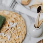 Discover eco-friendly bathroom essentials including wooden toothbrushes and bamboo cotton swabs for a zero waste lifestyle.