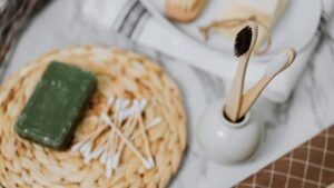 Discover eco-friendly bathroom essentials including wooden toothbrushes and bamboo cotton swabs for a zero waste lifestyle.