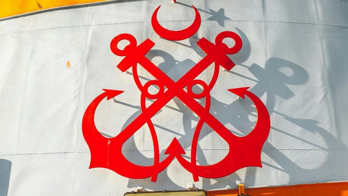 Bold red anchor design on a ship's funnel against a vibrant background.