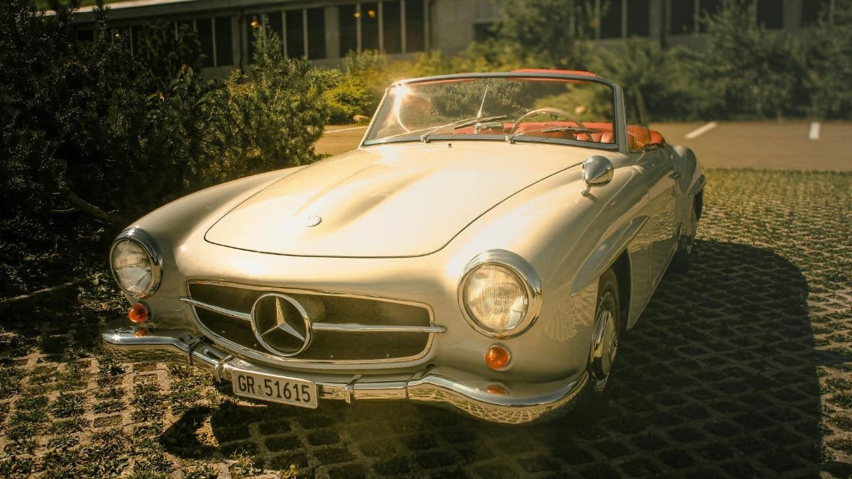 A classic convertible car in a sunny outdoor setting, perfect for vintage car enthusiasts.