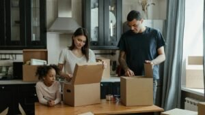 Family unpacking boxes in their new kitchen, enjoying a fresh start in a cozy home.