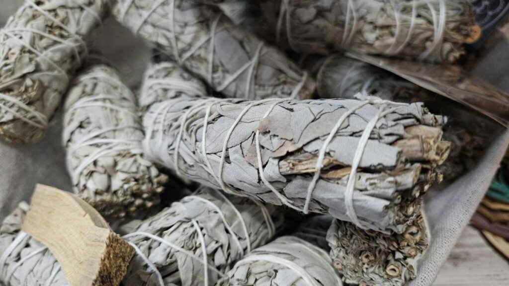 Close-up of dried white sage bundles used for smudging and cleansing rituals.