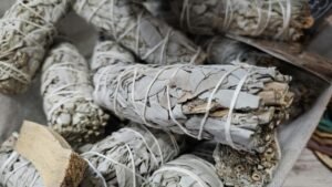 Close-up of dried white sage bundles used for smudging and cleansing rituals.