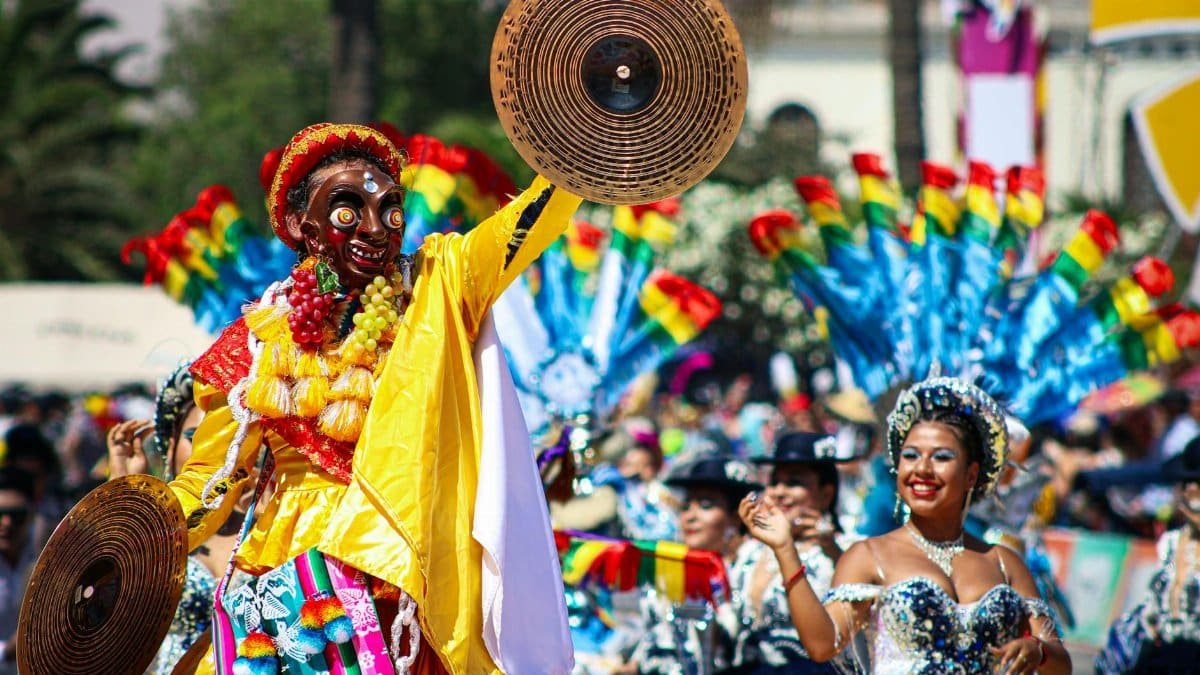 Colorful carnival with costumed dancers and cultural flair in Arica, Chile.