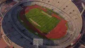 High-angle aerial view of an empty stadium with a field and track, showcasing its architectural design.