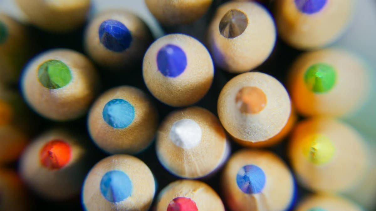 Close-up of vibrant colored pencils viewed from the top, showcasing sharpened tips.