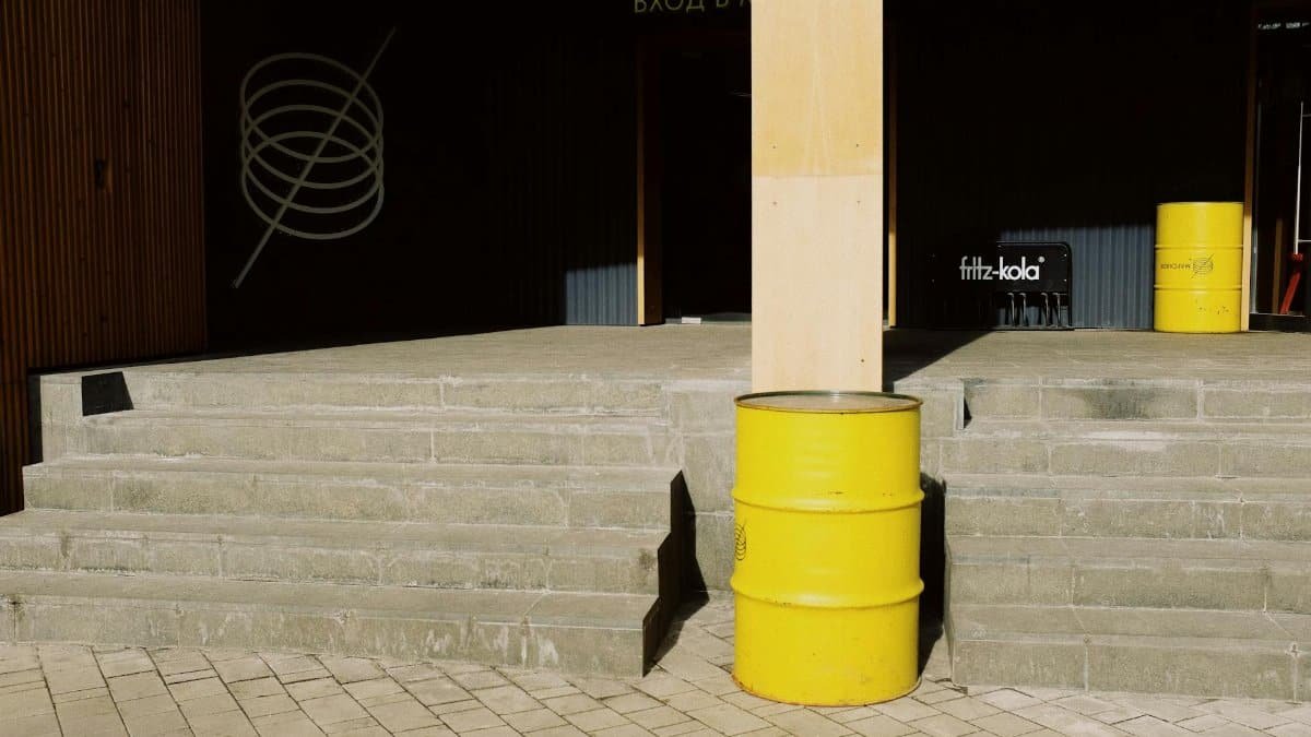 Urban steps with yellow barrels and industrial elements in daylight