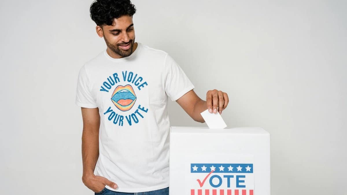 Man casting a vote in an election with a voting ballot box, promoting democratic participation.
