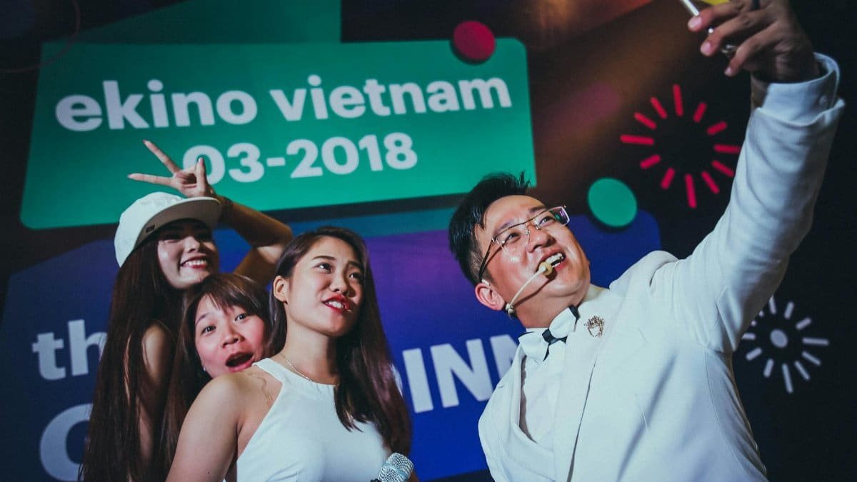 People enjoying a lively event in Vietnam, taking a group selfie.