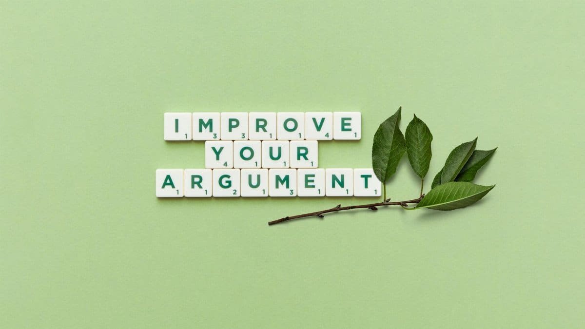 Scrabble tiles spelling 'Improve Your Argument' on a green background with leaves.