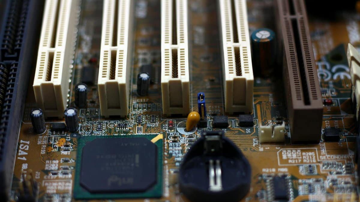 Detailed close-up of computer motherboard showing components like RAM slots and capacitors.