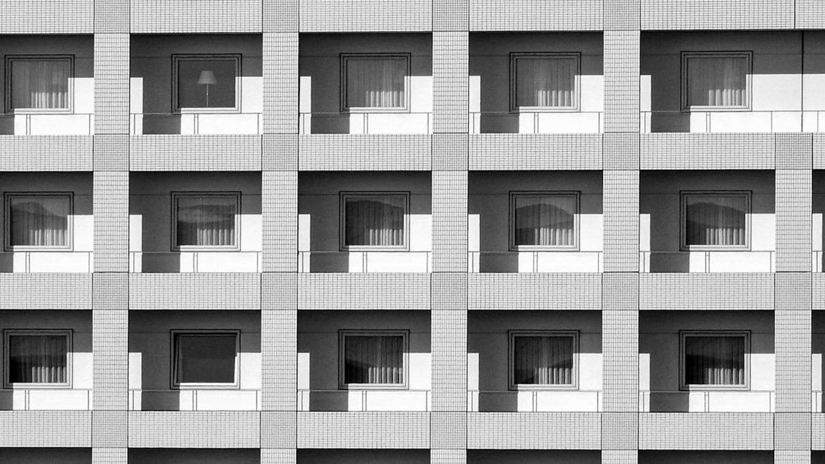 Modern building facade showcasing symmetrical architecture with repetitive window patterns in Japan.