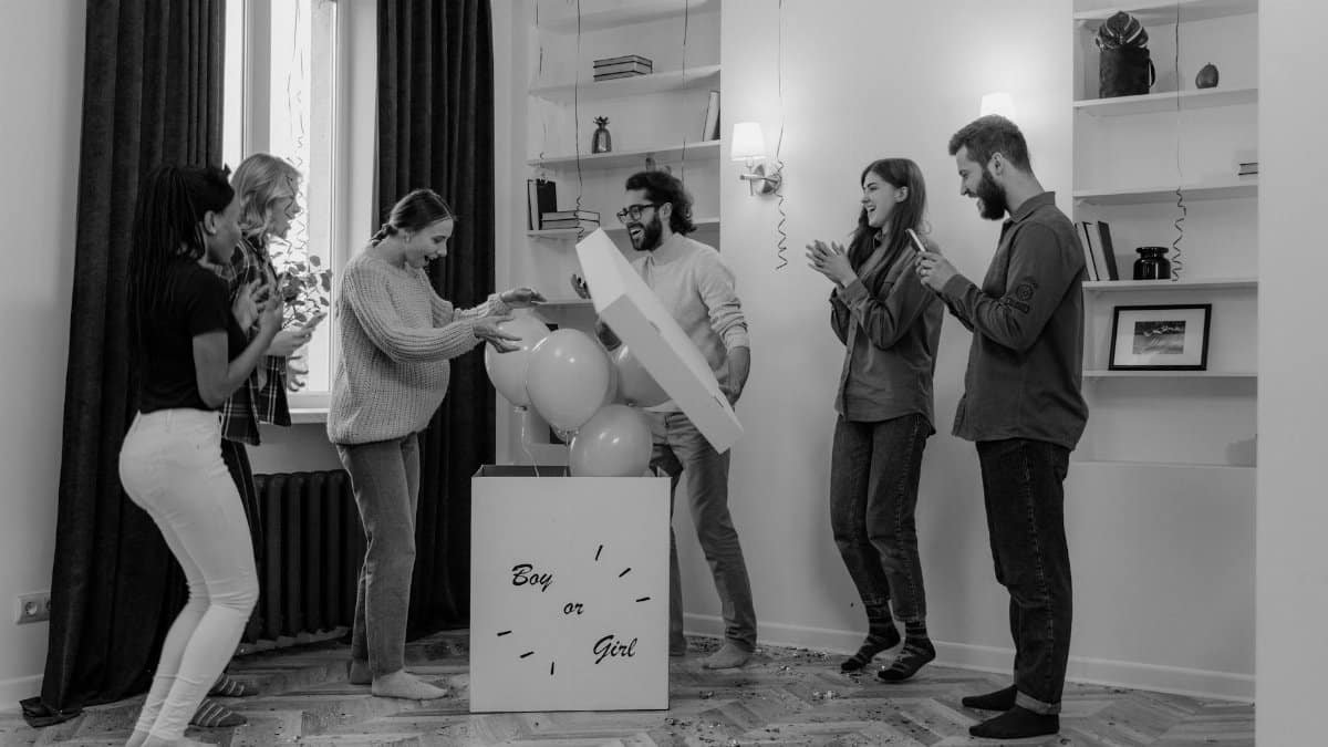 A joyful black and white gender reveal party among friends, adding excitement to the occasion.