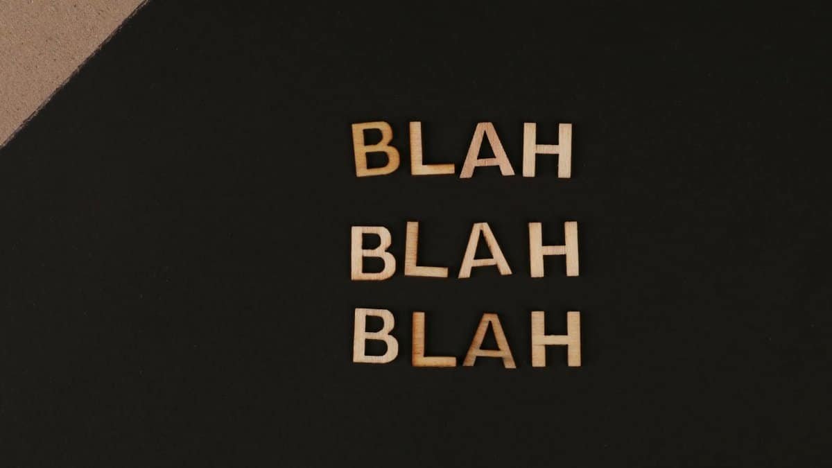 Close-up of wooden letters spelling 'blah', arranged on a black background, offering a conceptual design with copy space.