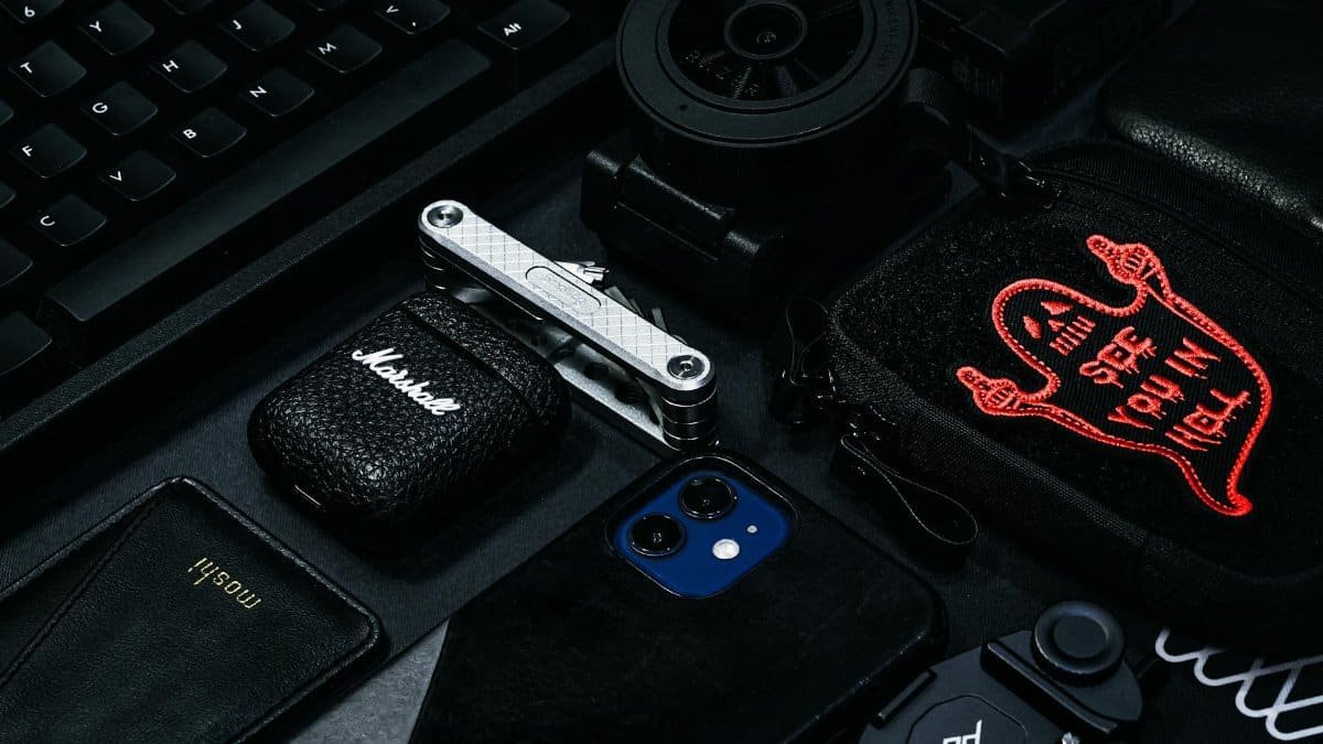 A stylish composition of modern gadgets and accessories including a keyboard, smartphone, and more.