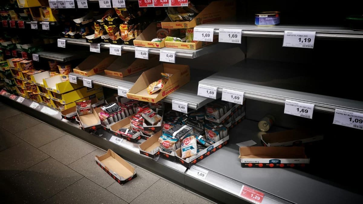 A view of partially empty supermarket shelves indicating high consumer demand or supply issues.