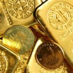 Close-up of shiny gold bars and coins, representing wealth and fortune.